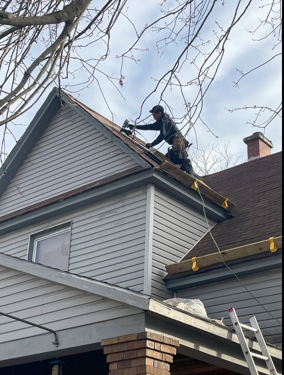 José installing roofing on a West Michigan home