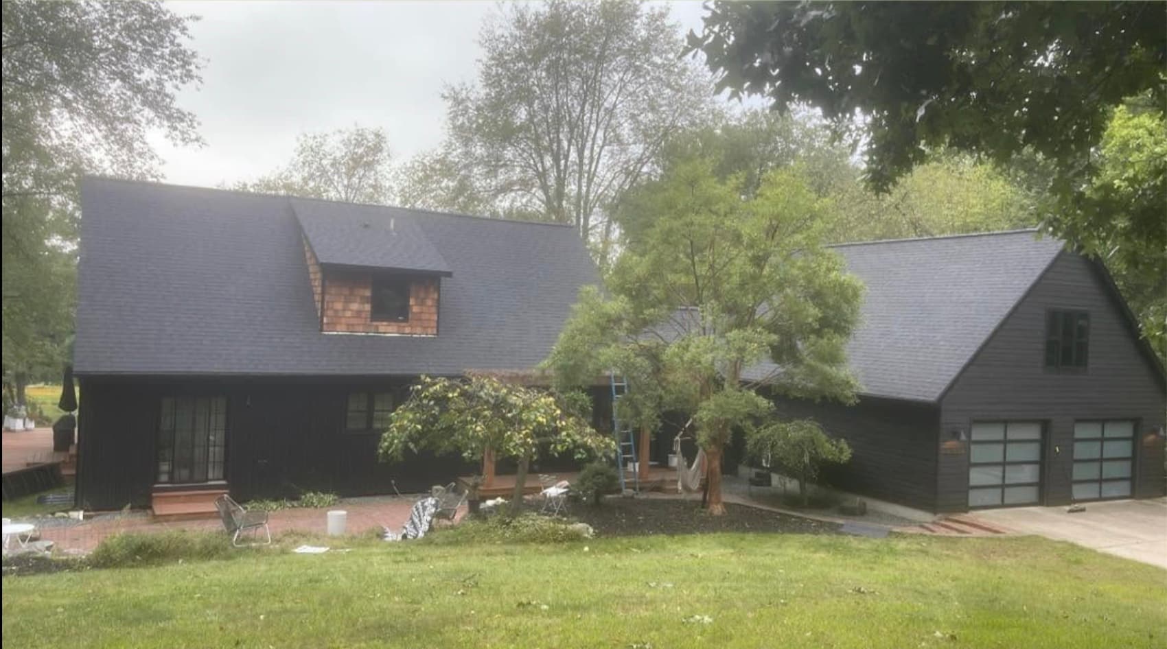 New dark shingle roof on a charcoal home
