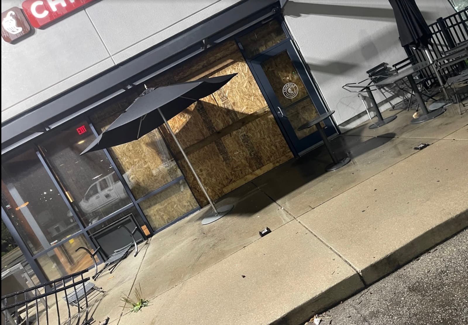 The storefront secured and boarded up at night