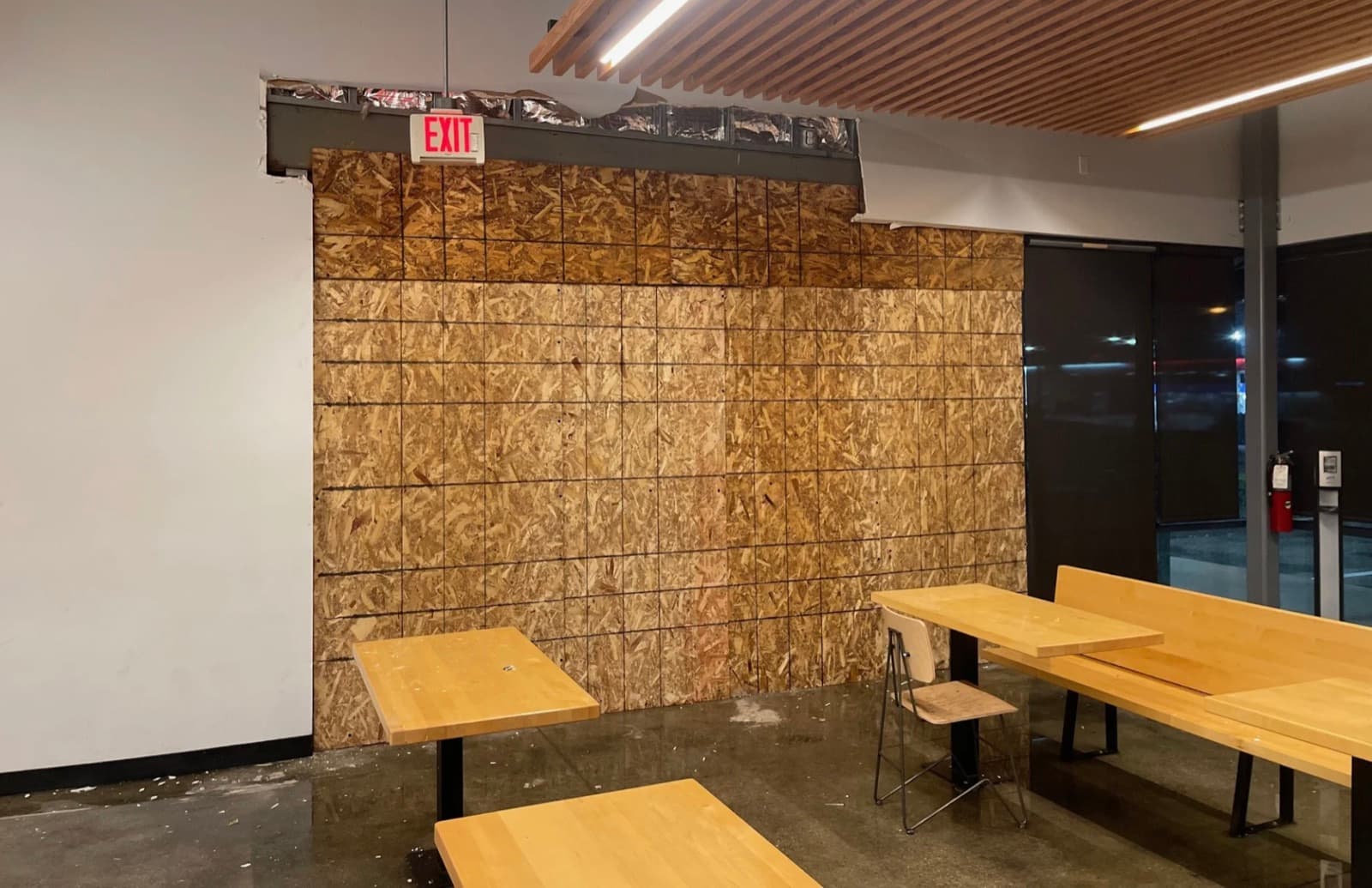 The interior of the storefront boarded up and weather-tight