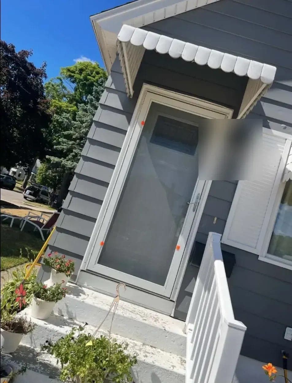 Finished entry with a new full-view storm door under a white awning