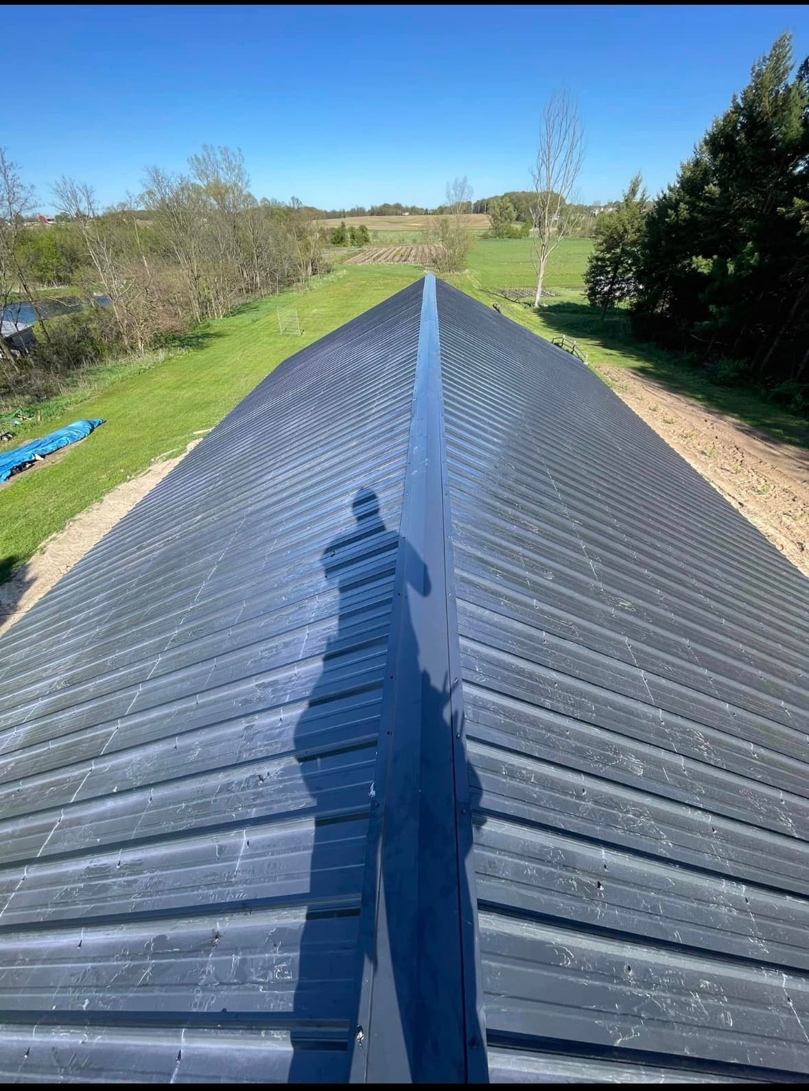 A long standing-seam metal roof on a rural West Michigan barn