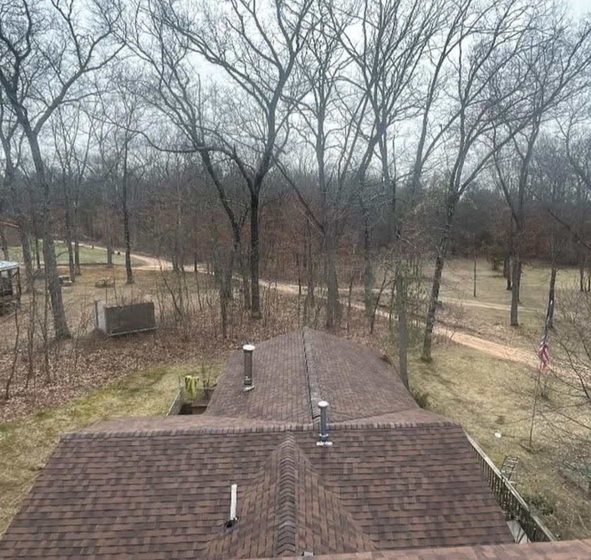 Finished re-roof on a wooded lot, aerial
