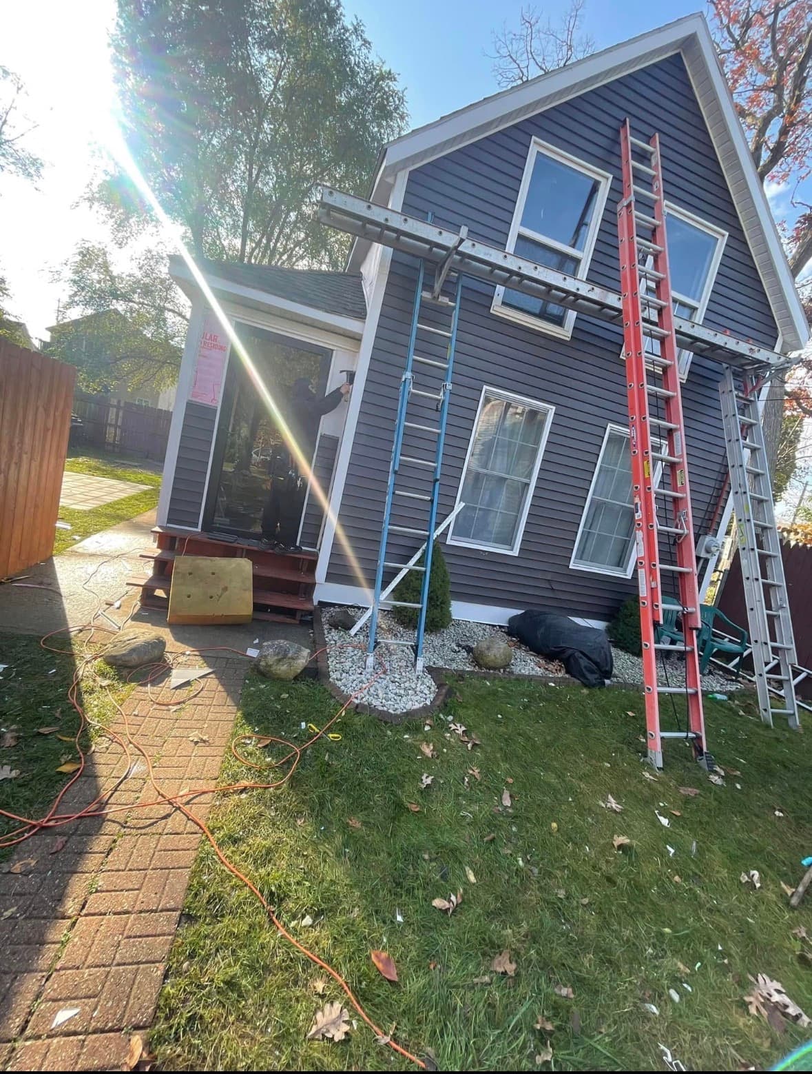 Same home after: finished dark siding with white trim